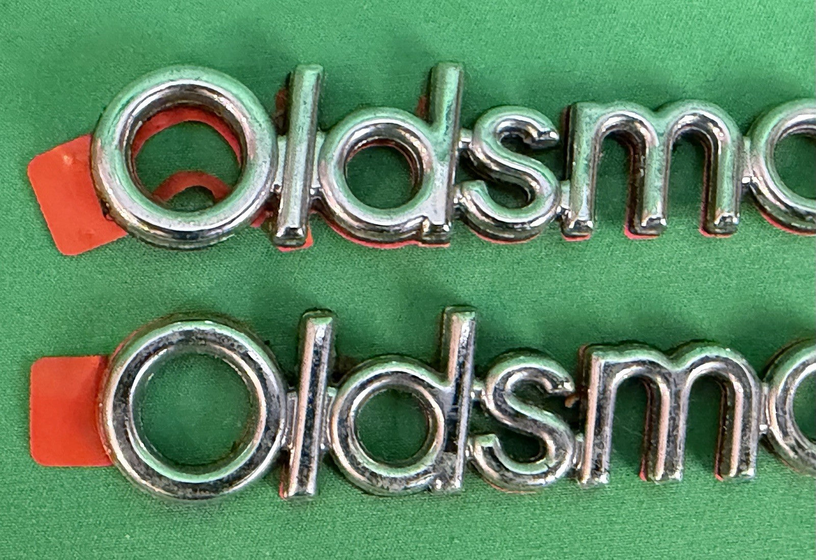 NOS Oldsmobile Nameplate Emblem Adhesive Mount GM 20000969 / 555735–Bundle of 2