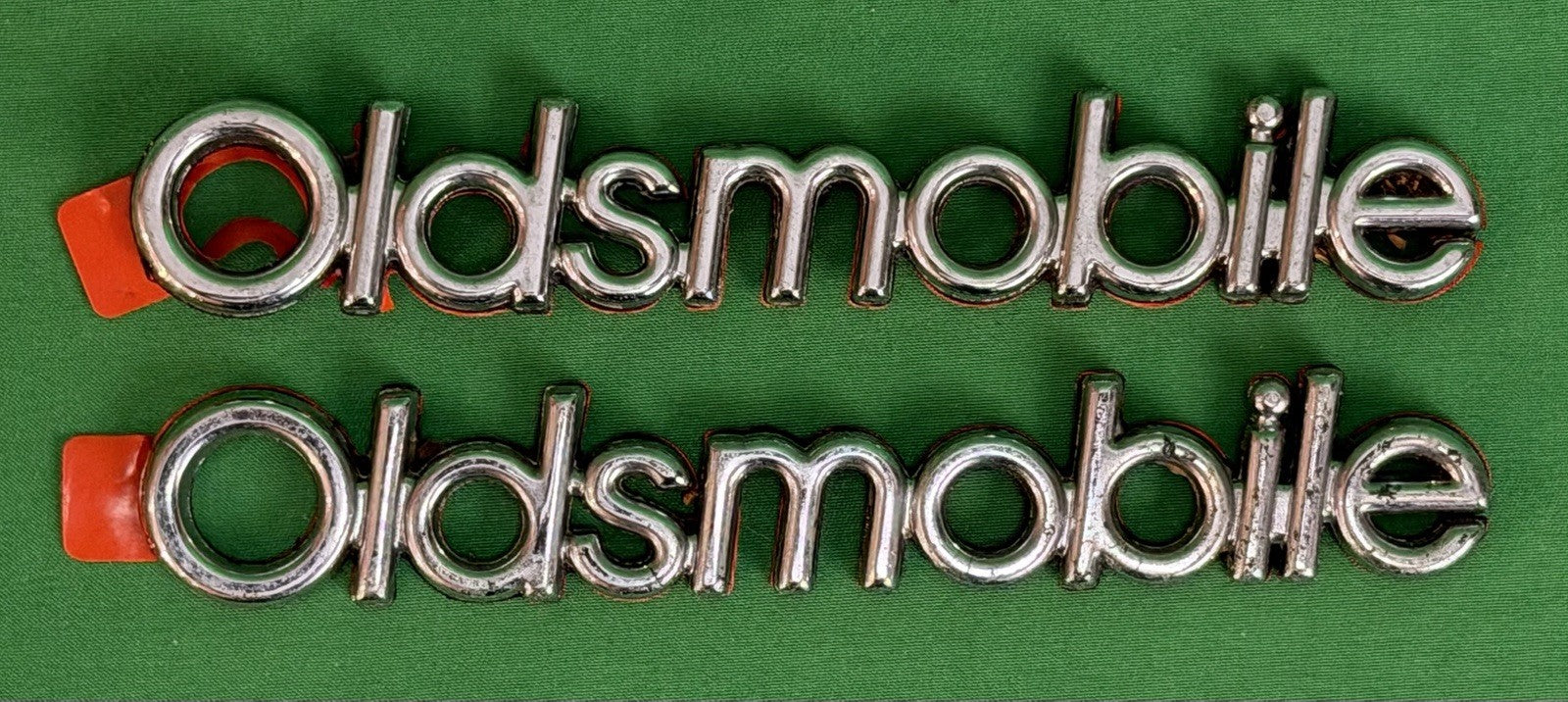 NOS Oldsmobile Nameplate Emblem Adhesive Mount GM 20000969 / 555735–Bundle of 2
