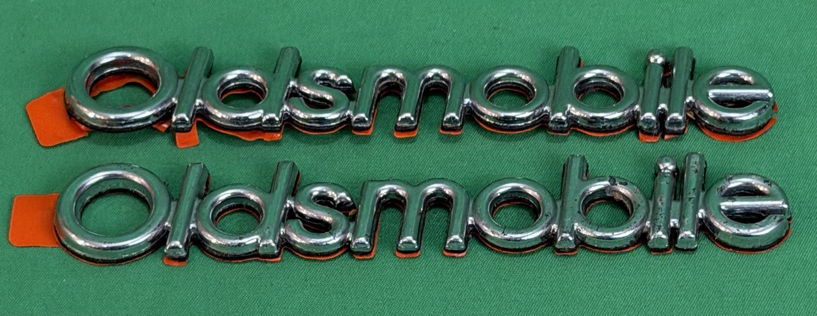 NOS Oldsmobile Nameplate Emblem Adhesive Mount GM 20000969 / 555735–Bundle of 2