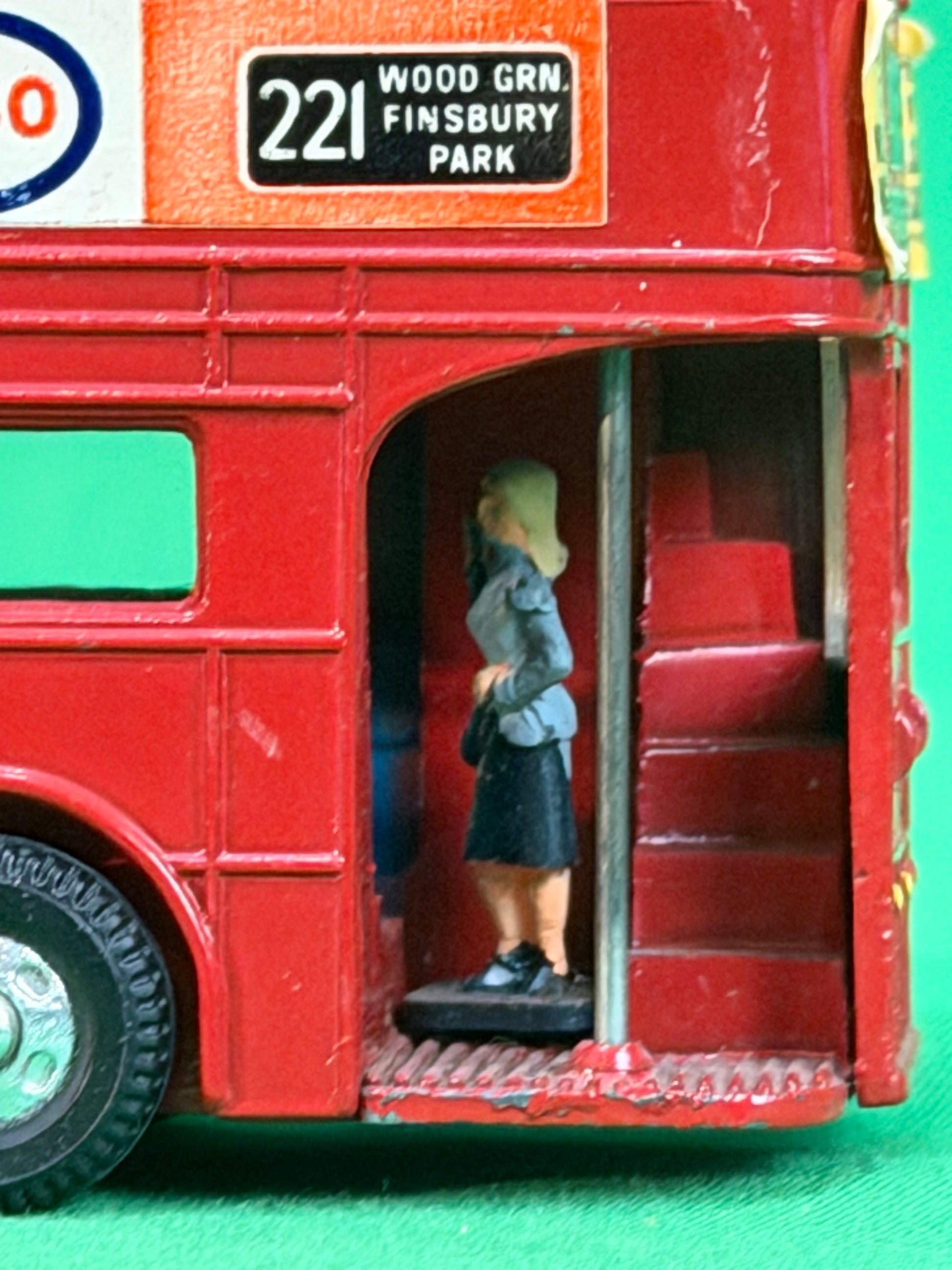 Female figure in Dinky Routemaster Double Decker Red Bus